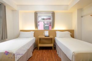 Ένα ή περισσότερα κρεβάτια σε δωμάτιο στο MySpace Hotel @BGC