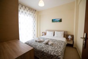 a hotel room with a bed with two pillows on it at Perfect Apartment in Nea Potidaea +25 photos