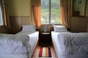 Llit o llits en una habitació de Hotel Mount Paradise