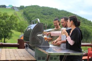 a group of people standing around a grill at Forest Inn Sangoro in Zaō Onsen