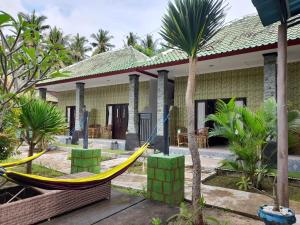 a house with a hammock in front of it at citiz's house in Nusa Penida