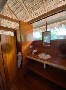 a bathroom with a sink and a mirror at Ecolucerna Lodge Tambopata in Puerto Maldonado