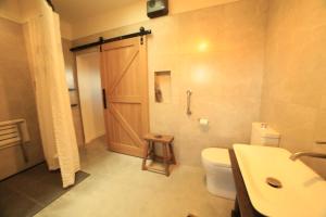 a bathroom with a toilet and a sink and a shower at Black Stilt Retreat, STUNNING luxury property in Twizel