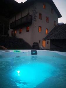 a large swimming pool in front of a house at Apartment Abinkar in Tolmin