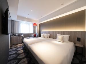 Postel nebo postele na pokoji v ubytování Hotel JAL City Toyama