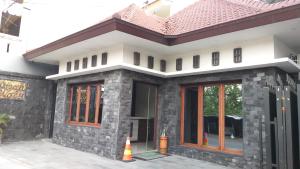 a rendering of a house with a brick exterior at Omah Watu Homestay in Yogyakarta