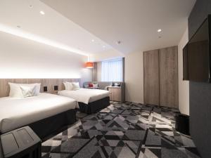 Postel nebo postele na pokoji v ubytování Hotel JAL City Toyama