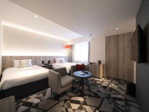 Postel nebo postele na pokoji v ubytování Hotel JAL City Toyama