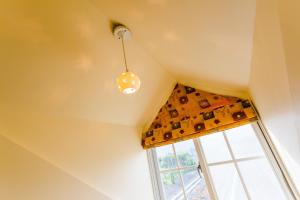 a ceiling light and a window in a room at Dream House in Pinghe