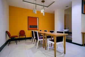 a dining room with a table and chairs at Urbanview Hotel Bes Mangga Besar by RedDoorz in Jakarta