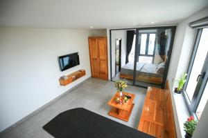 a living room with a table and a bed at LH APARTMENT DA NANG in Danang