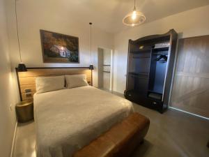 a bedroom with a bed and a television in it at Black Stilt Retreat, STUNNING luxury property in Twizel