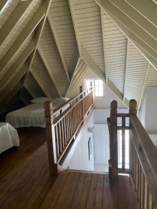 a attic room with a bed and a staircase at Seacastles by the beach/pool in Montego Bay