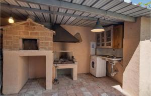 a kitchen with a brick oven and a stove at 1 Bedroom Cozy Home In Montegiovi in Montegiovi