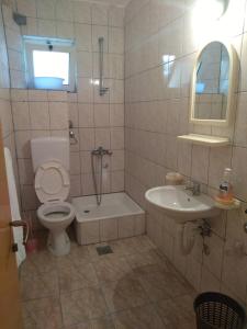 a bathroom with a toilet and a sink at Vito Apartments Sutomore in Sutomore +80 photos