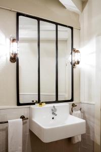 a bathroom with a sink and a large mirror at Hotel IRARAGORRI in Galdakao