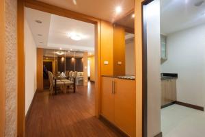 a hallway leading to a dining room with a table at 5A-Short-term rental allowed-2BRs Downtown Bangkok in Makkasan