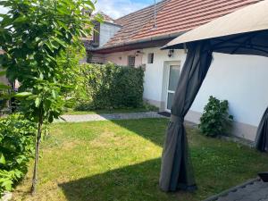 a black umbrella in the yard of a house at Private House Citadela Tg.Mures in Târgu-Mureş