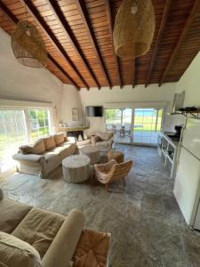 a living room with couches and tables and a kitchen at Ήλιος Villa in Ktima Gerostathi in Polykhrono