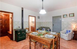 a living room with a table and a stove at Gorgeous Apartment In Magliano In Toscana With Wifi in Magliano in Toscana