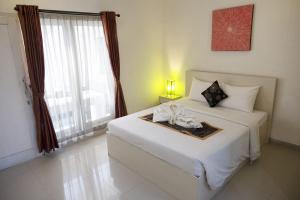 Letto o letti in una camera di Gaing Mas Residence By Gaing Mas Group