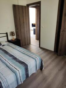 a bedroom with a bed and a wooden floor at Limassol Seaside Apartment in Limassol