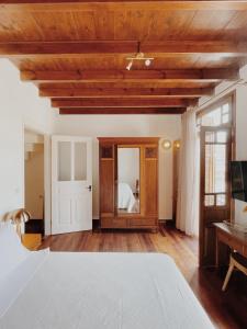 a bedroom with a bed and a wooden ceiling at Kale Kapi City Living in Chania
