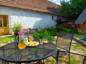 a glass table with a plate of food on it at Domek Dírná in Dírná