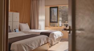 Postel nebo postele na pokoji v ubytování Denbasta forest Hotel