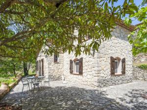 una casa in pietra con un tavolo e sedie di fronte di Majestic Villa in Callas France with Private Pool a Callas