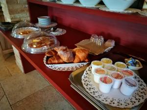 a buffet with bread and other food on a table at Agriturismo Il Falco in SantʼElpidio a Mare