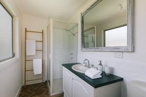 a bathroom with a sink and a mirror at Dovestones by the Sea Inverloch in Inverloch