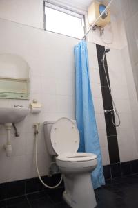 a bathroom with a toilet and a shower and a sink at Gaing Mas Residence By Gaing Mas Group in Jimbaran