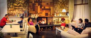 a group of people sitting in a restaurant with a fireplace at Hotel Santa Maria de Alquezar in Alquézar