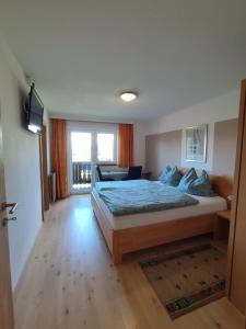 a bedroom with a large bed and a window at Haus Johanna in Westendorf