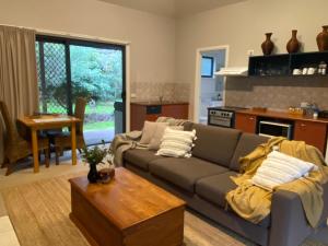 a living room with a couch and a table at Island Break Cottages in Cowes