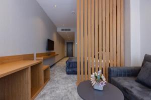 a living room with a couch and a table at Hotel Monarch in Batumi