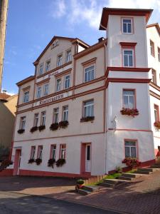 a large white building with flowers in front of it at Hotel Klostergarten in Eisenach