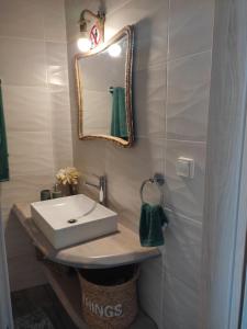 a bathroom with a sink and a mirror at Peace & View in Archangelos