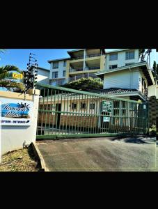 a large building with a fence next to a street at 42 Ramsgate palms in Margate
