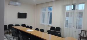 a conference room with a wooden table and chairs at Hotel Posta Khulo in Khulo