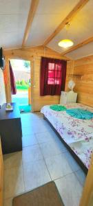 a bedroom with a bed in a wooden room at Casa Gabriela in Vama Veche