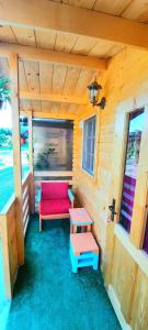 a room with a red bench and a table at Casa Gabriela in Vama Veche