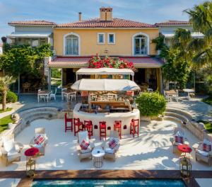 an aerial view of a house with a pool and tables and chairs at La Capria Suite Hotel Alacati in Alacati