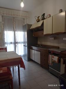 a kitchen with a sink and a stove top oven at DOWN TOWN EMILY in La Spezia
