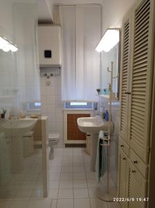 a white bathroom with a sink and a toilet at DOWN TOWN EMILY in La Spezia