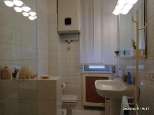 a bathroom with a sink and a toilet and a mirror at DOWN TOWN EMILY in La Spezia +15 photos