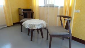 a table and two chairs in a room at Threshershack Inn in Malapascua Island