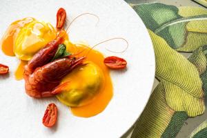 a plate of food with a lobster and sauce at Hotel Villa Carlotta in Taormina