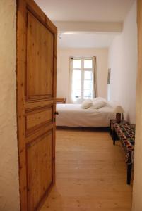 an open door leading to a bedroom with a bed at Appartement de charme au cœur d une cité médiévale in Villefranche-de-Conflent